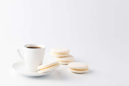 Minimalistic shot of espresso cup with one white macaroonの写真素材