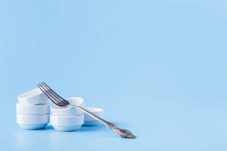 Pile of small bowl and fork, serving exampleの写真素材
