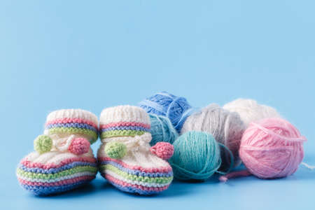 Knitting baby shoes with multicolor yarnの写真素材