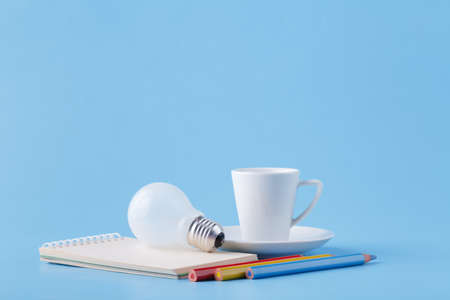 Ideas and energy for artist, coffee, light bulb and colour pencils