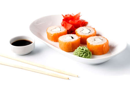 Delicious sushi rolls on white plate with chopsticks and wasabi. Makiの写真素材