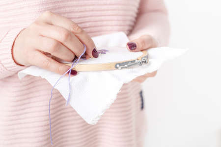 cross-stitched pillow in female handsの写真素材