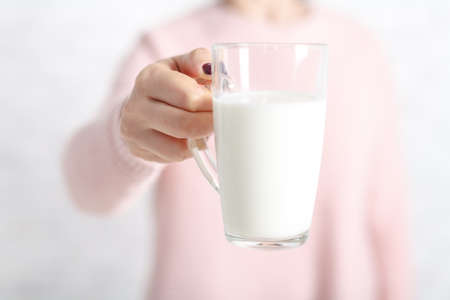 a woman gives you a cup of milk