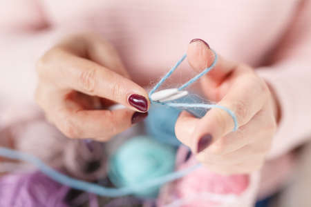 Woman knitting baby things in hand