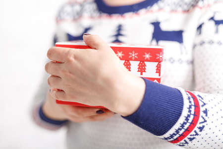 Christmas gift box in female hands, clopse up viewの写真素材
