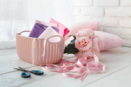 Knitten things and needlework accessories in home organizers colored baskets