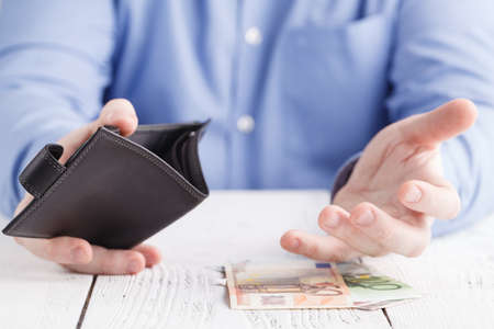 people, business, finances and money concept - close up of businessman hands holding open wallet with euro cashの写真素材