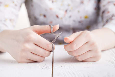 Health and personal care: Hand holding scissors for manicureの写真素材