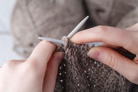 Knitting a wool scarf, closeup of the handsの写真素材