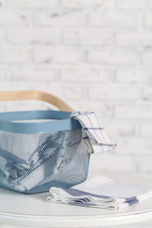 towels in basket and pins on light backgroundの写真素材