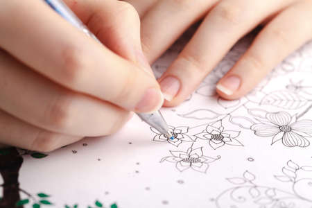 Female stress relief painting in adult painting bookの写真素材