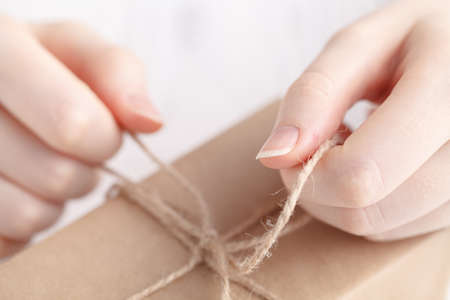 Packing gift in craft papper with twineの写真素材