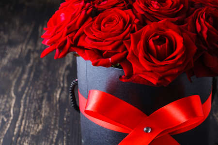Red roses in box on dark backgroundの写真素材