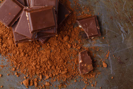 Natural dark chocolate pieces on wooden tableの写真素材