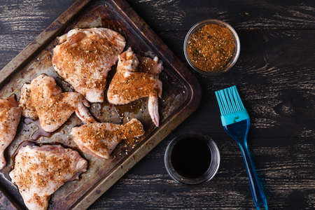 Raw chicken with spices ready to cookの写真素材