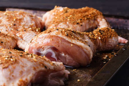 Cooking chicken leg, close up with spicesの写真素材