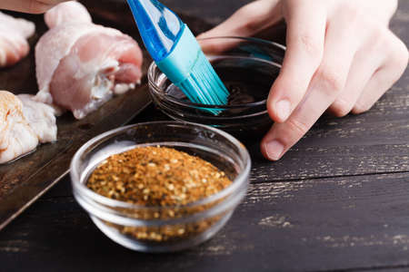 Raw chicken legs with salt pepper and herbsの写真素材