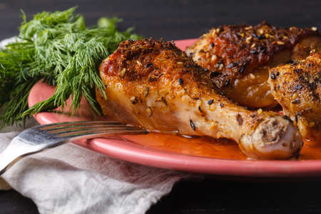 Marinated grilled healthy chicken breasts cooked on a summer BBQ and served with fresh herbs