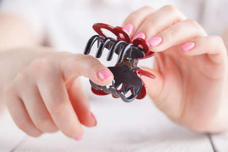uman's hand holding hairclip openedの写真素材