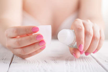 deodorant roll in female hands
