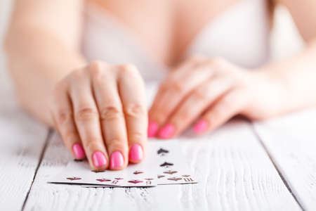 a female hand playing cards