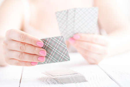 Female hold few playing cards with cover