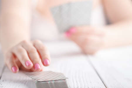 ladies gathered playing black jack cards for moneyの写真素材