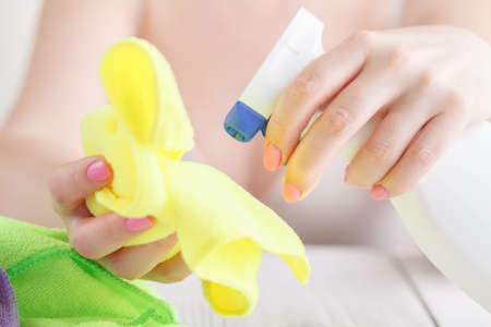 Spray for clearing glass in female hands