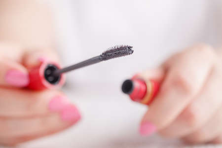 Eyelash makeup brush and mascara bottle close upの写真素材