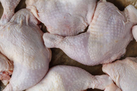 Raw chicken legs close up on trayの写真素材