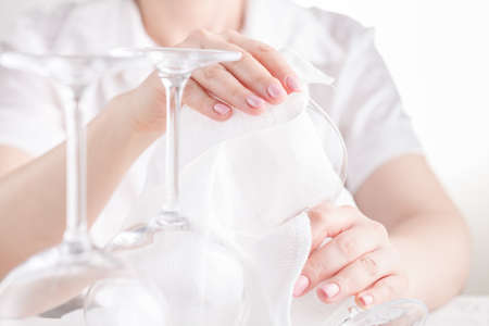 Female wipes wine glassesの写真素材