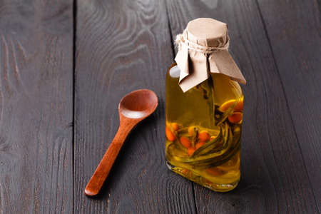 Bottles of extra virgin olive oil with aromatic herbsの写真素材