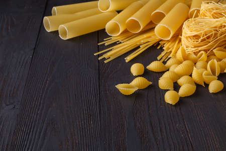 Italian foods concept and menu design, spaghetti. Various kind of Pasta on a black backgroundの写真素材