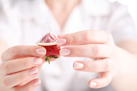 Contraception concept, condom in female handsの写真素材
