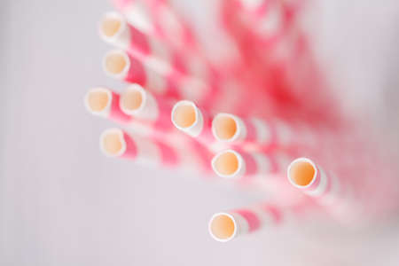 striped cocktail straws in glass overhead viewの写真素材