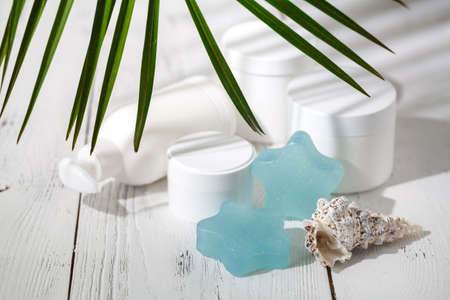 Cosmetic cream and beautiful spa containers on white tableの写真素材