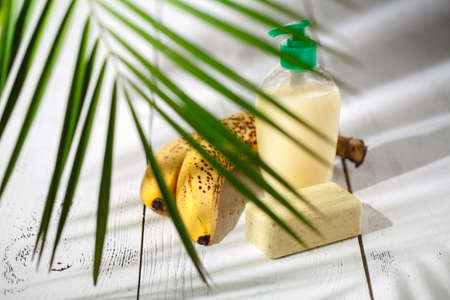 delicate natural cosmetics wor skin care on white table with green leavesの写真素材
