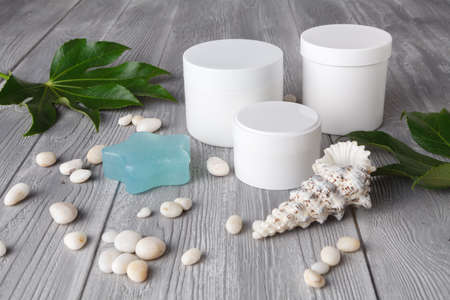 Spa procedure concept, different cosmetic jar and bottle on wooden tableの写真素材