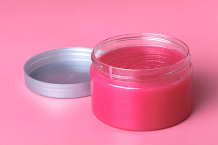 Round packaging of cream. Jar of cream isolated on pink backgroundの写真素材