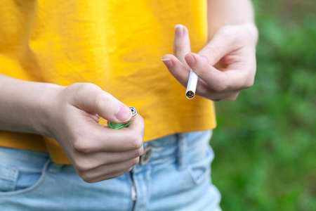 Female hand holding cigaretteの写真素材
