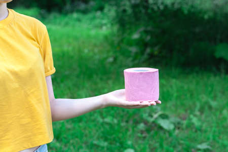 Female Hold toilet paper outdur nature. Concept of diarrhea in summer seasonの写真素材