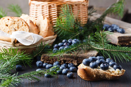 Cup of tea with berry jam on old wooden tableの写真素材