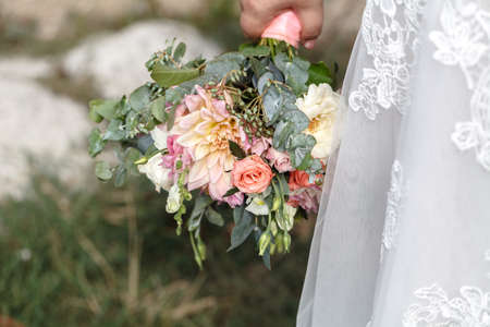 Beautiful plus size bride in the long sleeved dresswith flowers.Bridal morning details.の写真素材