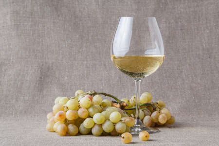 Glass of cold white wine with fruitsの写真素材