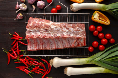 Raw pork meat. Fresh steaks on slate board on black background. Top viewの写真素材