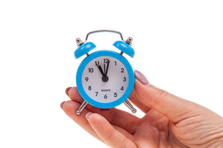 small alarm clock in hand, concept of being in time