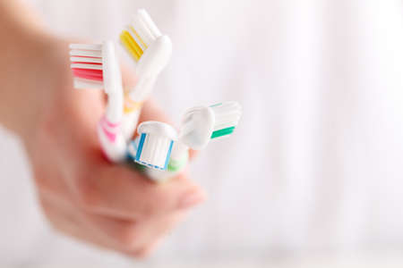 Woman holding manual toothbrushesの写真素材