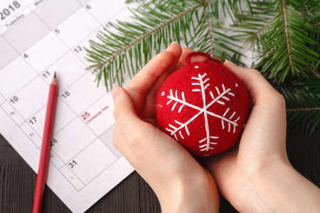 Red pen pointed to Christmas day text on calendar backgroundの写真素材