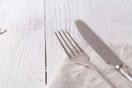 Knife, fork with linen serviette on the whiteの写真素材