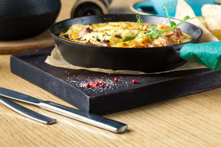 Ham and egg omelette, bio eggs, fresh herbs in breakfast setの写真素材